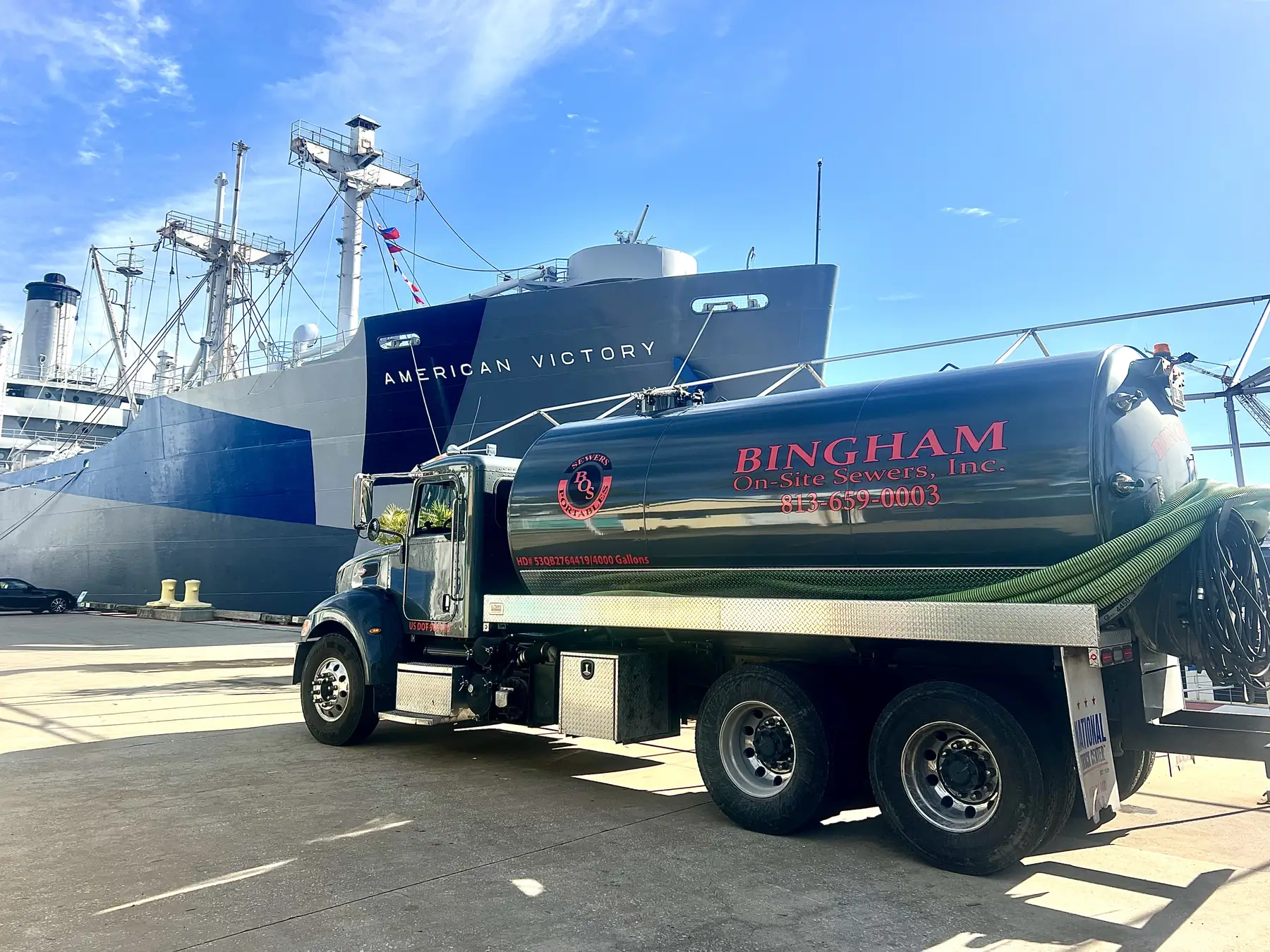 Bingham On-Site Sewers pump truck at the port beside the American Victory ship