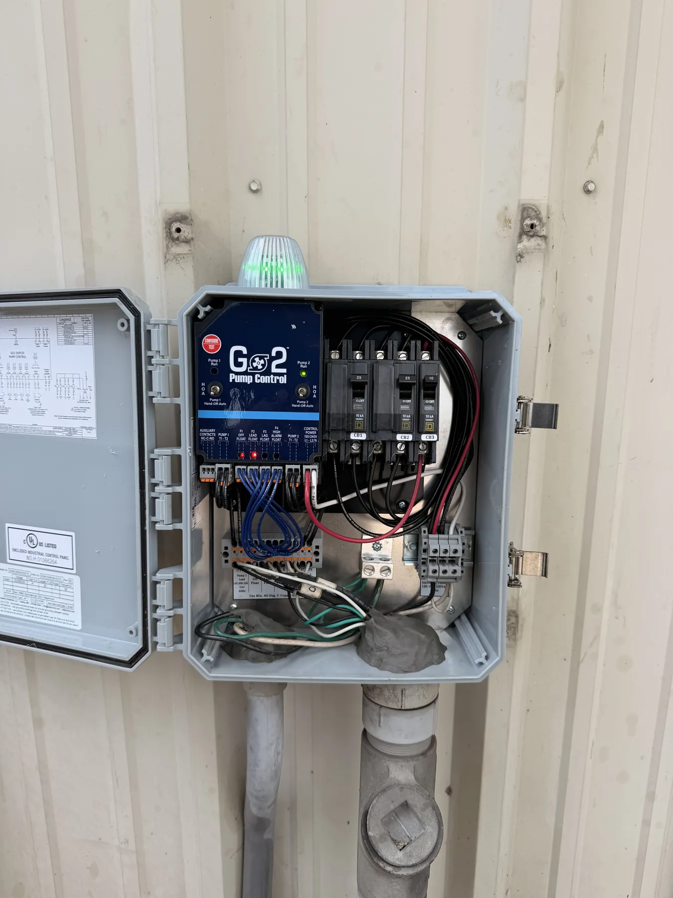 Open G2 pump control panel showing breakers, controller and wiring during service